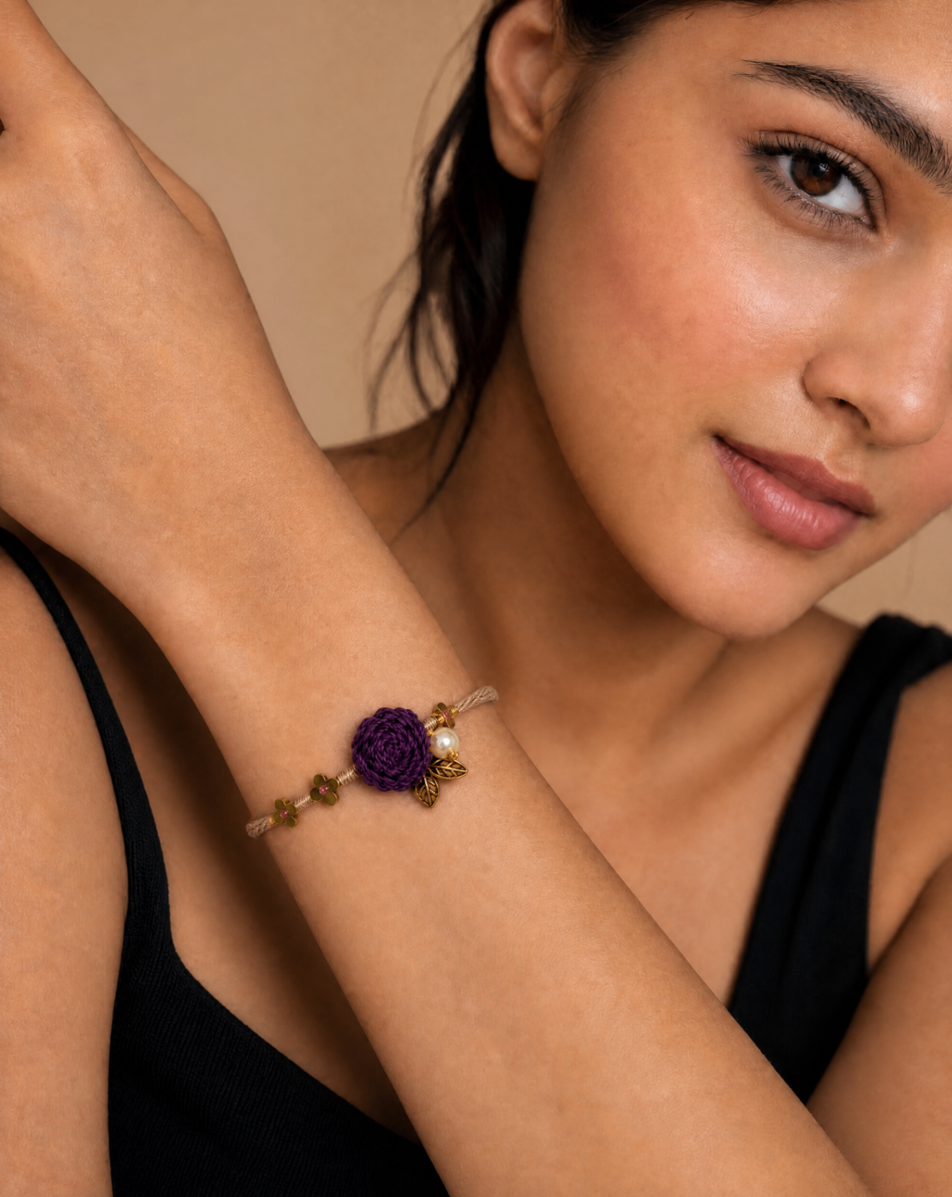 Woman wearing a floral bracelet in a warm editorial portrait